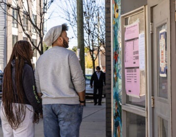 Voters review the ballot before heading into their polling place