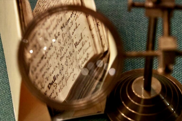 An archival handwritten notebook is on display