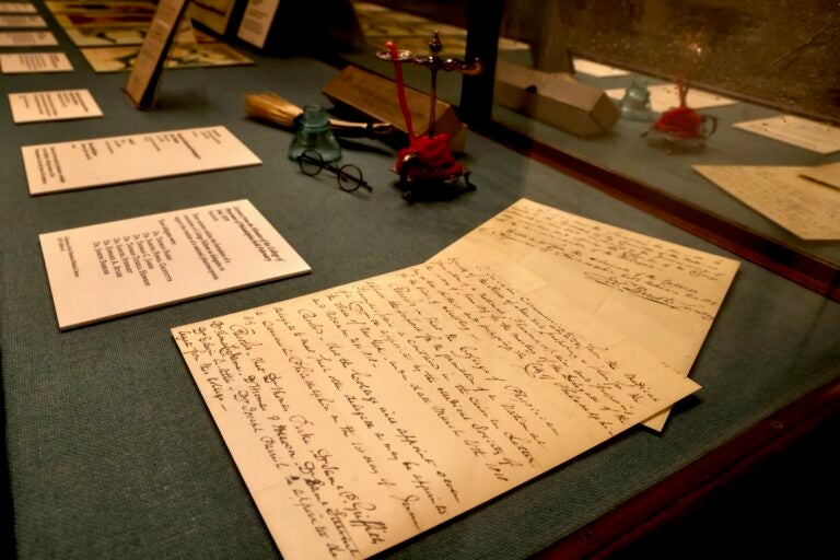 Handwritten notes shown in a display case