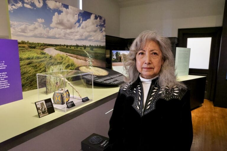 Amy Mossett is posing for a photo inside the exhibit
