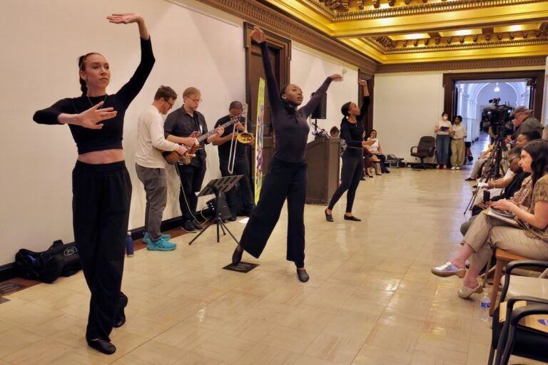Dancers and musicians from Putty Dance Project perform in a hallway on the fifth floor of City Hall