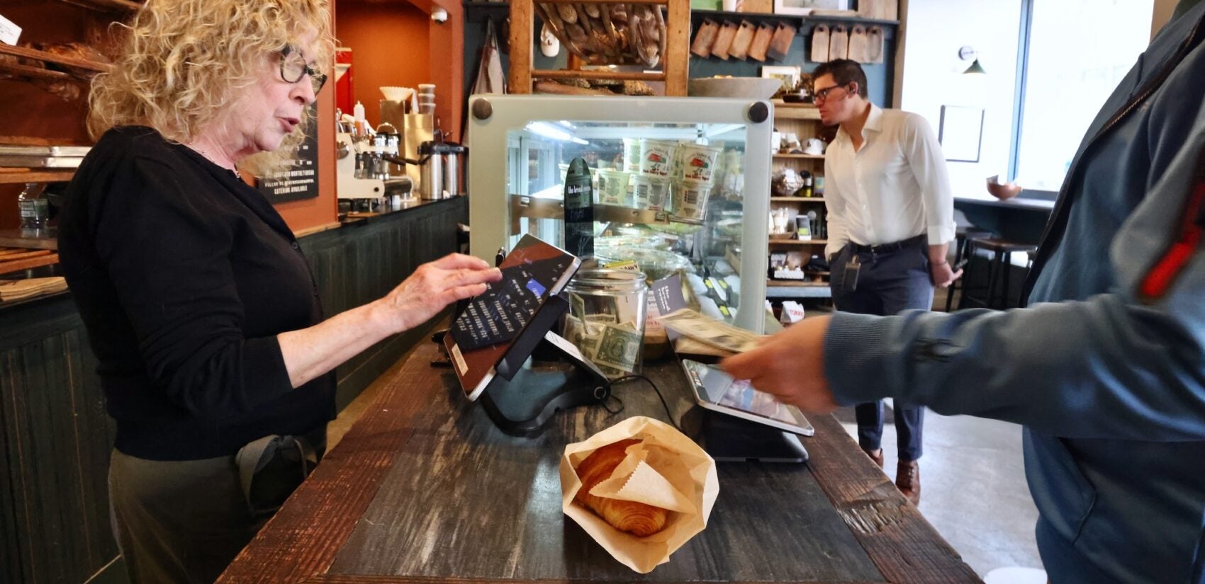 a customer checks out at The Bread Room