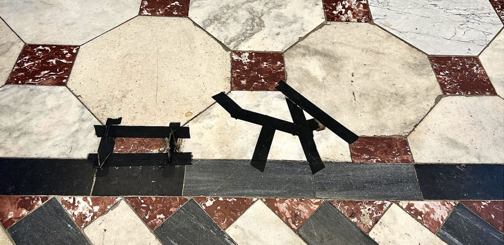 black tape on the marble floor