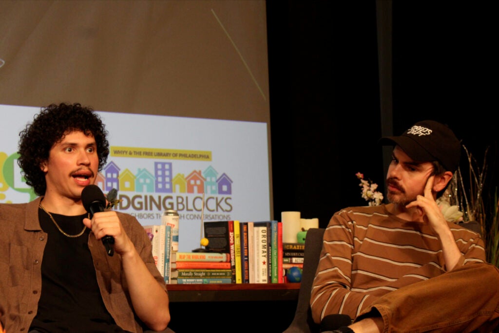 From left, Santiago Ortiz, content creator at No Shorts Media, and Conrad Benner, founder of Streets Dept., speak into microphones at the WHYY Civic News Summit