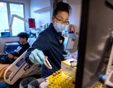 Clinical research nurse Monica Falcon prepares to draw blood from college student and research subject Sam Srisatta at the National Institutes of Health in Bethesda, Md., on Thursday, Oct. 31, 2024. (AP Photo/Mark Schiefelbein)