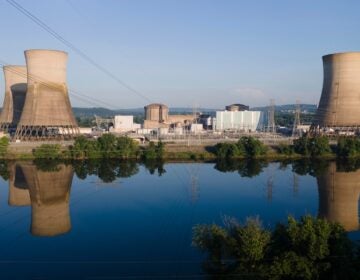 At Constellation's nuclear power plant on Three Mile Island, called the Crane Clean Energy Center, near Middletown, Pa., the cooling towers are reflected in the Susquehanna River at sunrise, June 25, 2025.