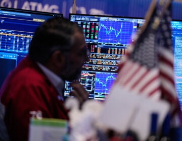 Screens display financial information on the floor at the New York Stock Exchange in New York, Tuesday, March 31, 2026. (AP Photo/Seth Wenig)