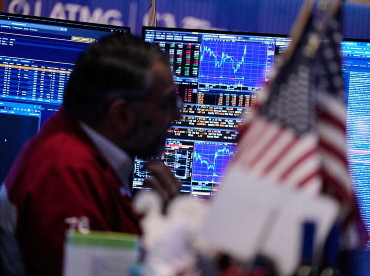 Screens display financial information on the floor at the New York Stock Exchange in New York, Tuesday, March 31, 2026. (AP Photo/Seth Wenig)