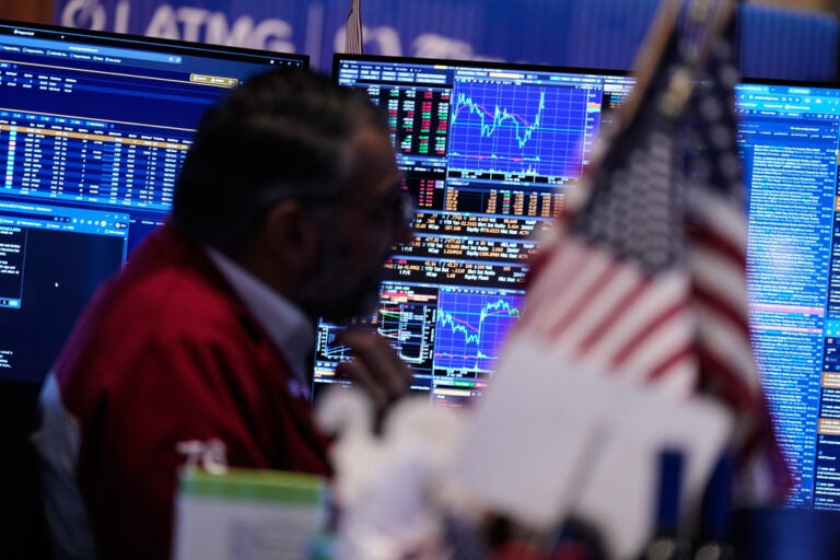 Screens display financial information on the floor at the New York Stock Exchange in New York, Tuesday, March 31, 2026. (AP Photo/Seth Wenig)