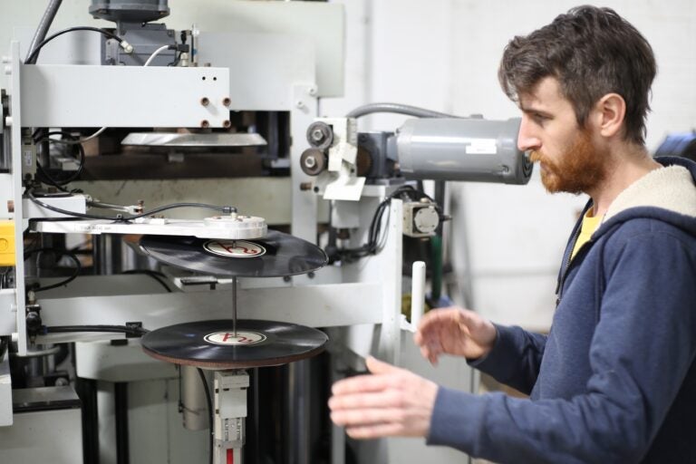 Nick Landstrom looks over a run of test presses