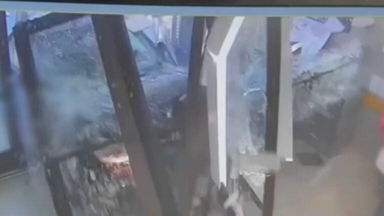 A man drives through the Philadelphia 2nd District police building