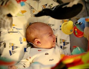 An overhead view of a baby in a crib