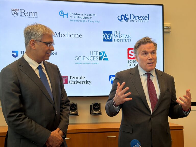 NIH director Jay Bhattacharya (left) listens as Sen. Dave McCormick