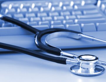 Stethoscope stitting on a computer keyboard