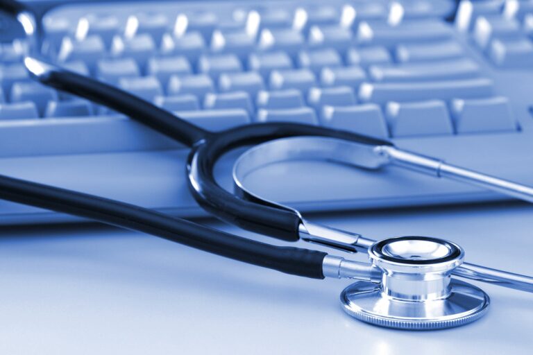 Stethoscope stitting on a computer keyboard