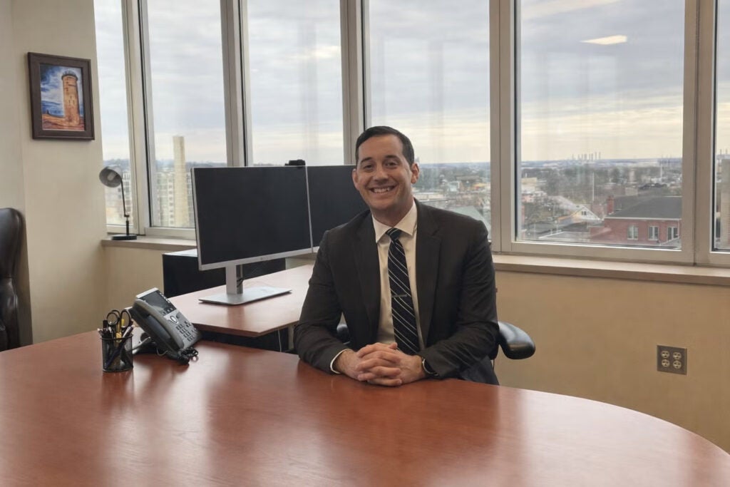 Benjamin Wallace posing for a photo in his office