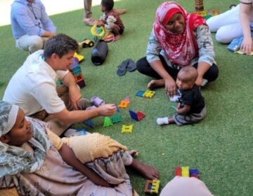 Bryan Shupe interacting with Palestinian child