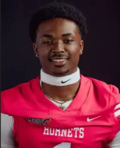 Malachi Biggs posing for a photo wearing his football uniform