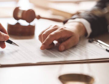 Concept of justice, law and legal system Hands point to a piece of paper