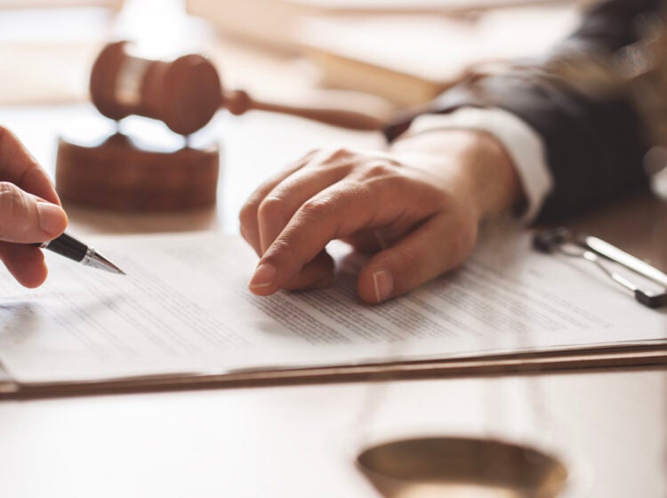 Hands point to a piece of paper