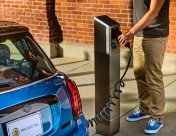 A person is charging an electric vehicle