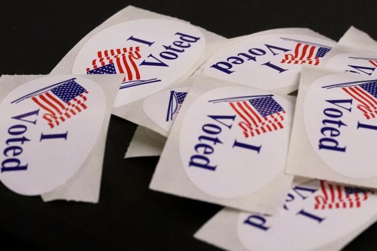 ''I Voted'' stickers rest on a ballot box at a polling place.