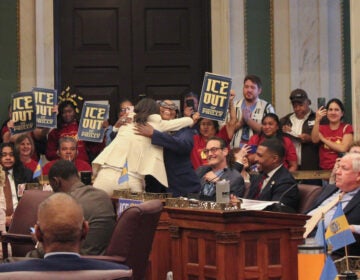 Rue Landau and Kendra Brooks hugging in Council chambers after the vote