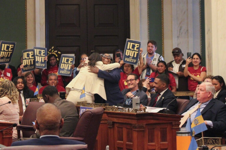 Rue Landau and Kendra Brooks hugging in Council chambers after the vote