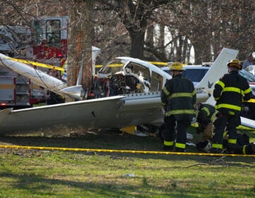 Firefighters respond to the scene after a small airplane made a crash landing