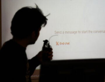 Student Surya Newa is silhouetted while using an oral AI agent