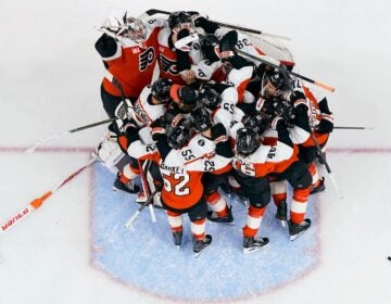 Hurricanes Flyers Hockey The Philadelphia Flyers gather around the net of goalie Dan Vladar, top left, as they celebrate after making the playoffs after an NHL hockey game against the Carolina Hurricanes, Monday, April 13, 2026, in Philadelphia.