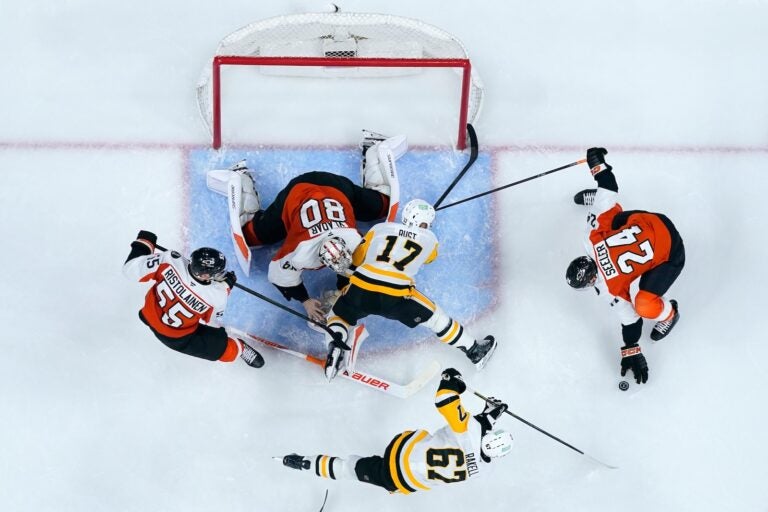 Pittsburgh Penguins' Bryan Rust (17) collides with Philadelphia Flyers' Dan Vladar (80) during the third period of Game 3 in the first round of the NHL Stanley Cup hockey playoffs Wednesday, April 22, 2026, in Philadelphia.