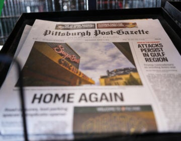 The printed edition of the Pittsburgh Post-Gazette sits in a newspaper rack
