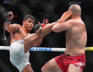 Paulo Costa, left, of Brazil, fights Azamat Murzakanov, of Russia