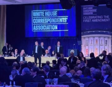U.S. Secret Service agents surround President Donald Trump as he is taken from the stage after a shooting incident outside the ballroom during the White House Correspondents Dinner