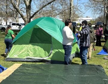 Javier Horstmann, an official with Wilmington Mayor John Carney's office, speaks with an unhoused resident