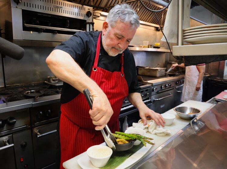 Guillermo Veloso prepares a plate of food