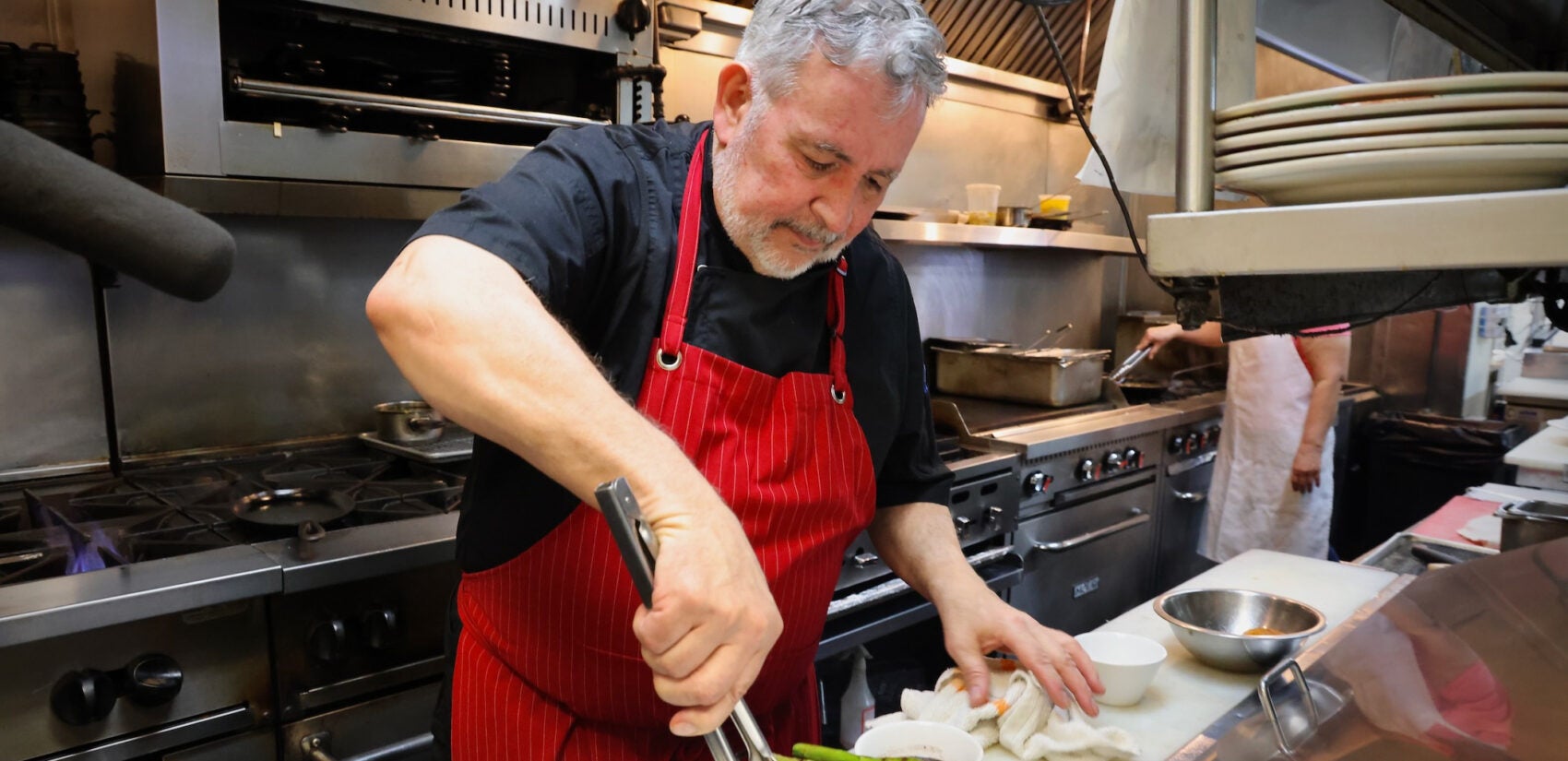 Guillermo Veloso prepares a plate of food