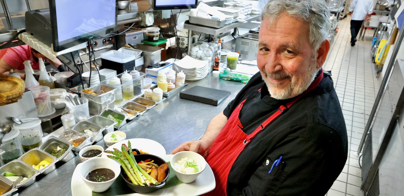 Guillermo Veloso holds a plate of food