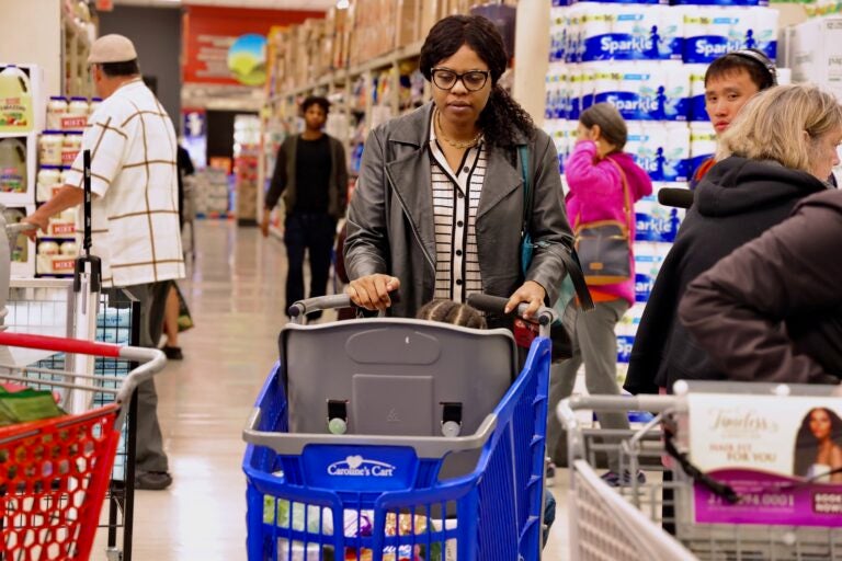 Constance Jones uses a Caroline's Cart to shop with her son at ShopRite