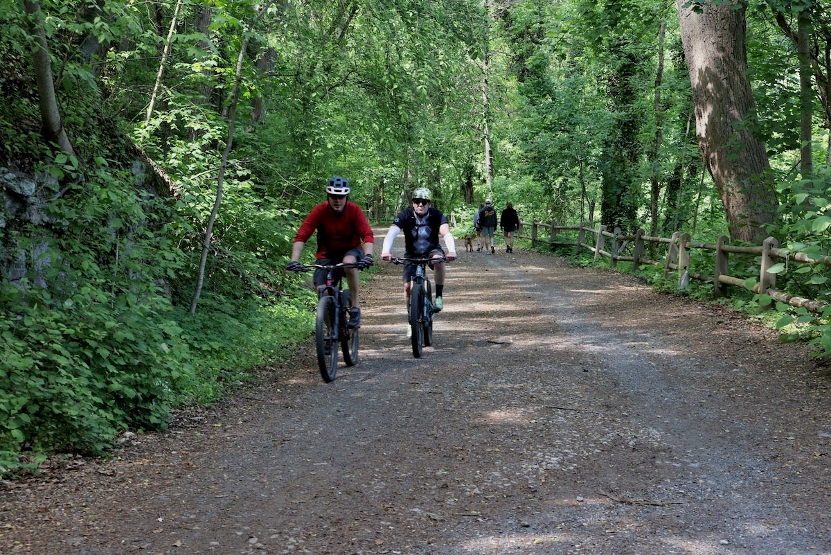 Bicyclists ride along Wissahickon Valley Park