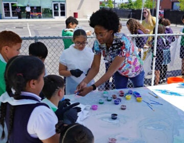 Pan American Academy Charter School mural Nilé Livingston helps students at Pan American Academy Charter School in Kensington paint a mural