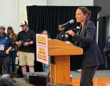 alexandria-ocasio-cortez-2026-05 Alexandria Ocasio-Cortez speaks to a crowd