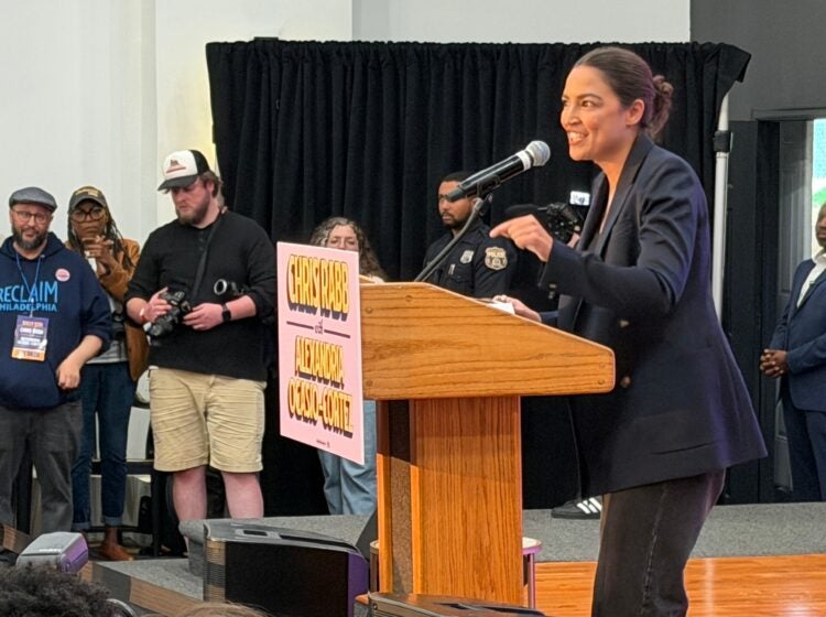 Alexandria Ocasio-Cortez speaks to a crowd
