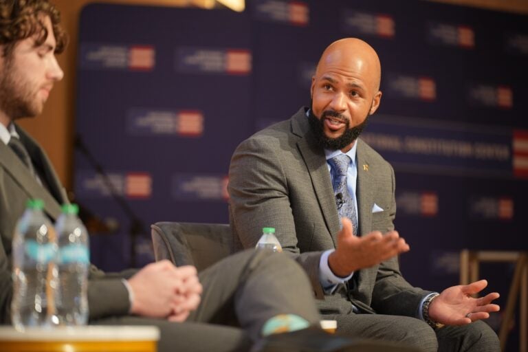 Leon Smith, the 2026 National Teacher of the Year and a history teacher at Haverford High School, compares the impact of the American Revolution and Reconstruction era on American society. (Joe Kaczmarek for WHYY News)