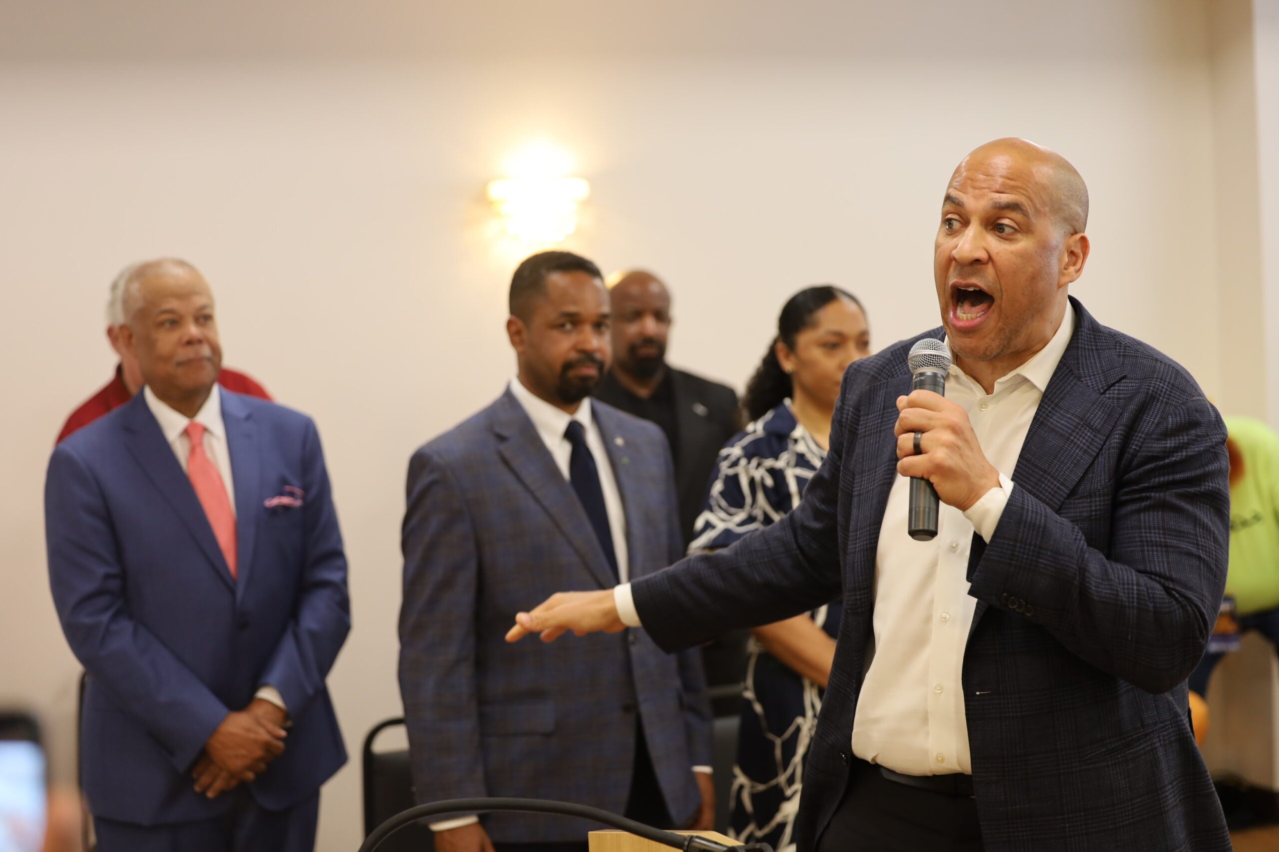 Cory Booker speaks into a microphone
