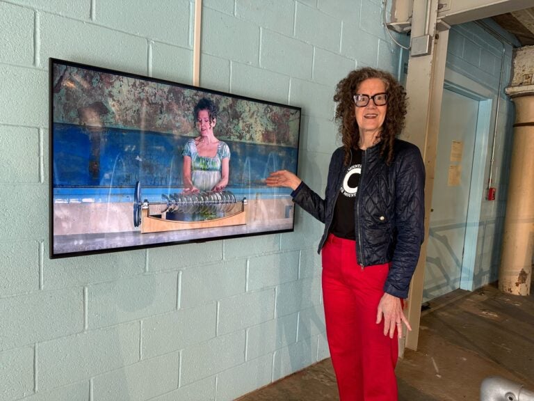 Martha McDonald watches herself on screen playing the armonica