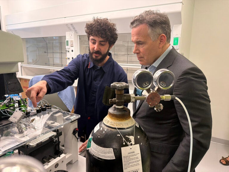 A bioengineering graduate student working at Penn's AIRFoundry, explains some of the lab's cutting edge medical research using artificial intelligence to Senator David McCormick.