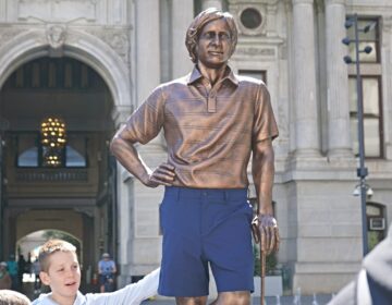 A statue of professional golfer Forrest Fezler in Dilworth Park