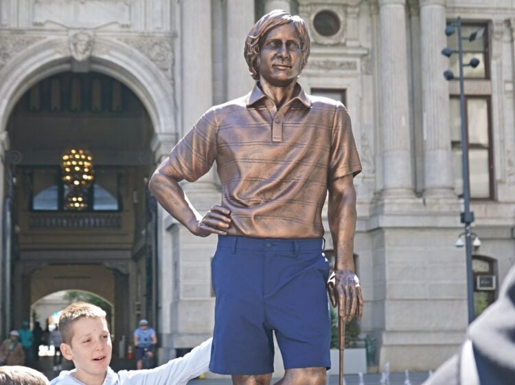 A statue of professional golfer Forrest Fezler in Dilworth Park